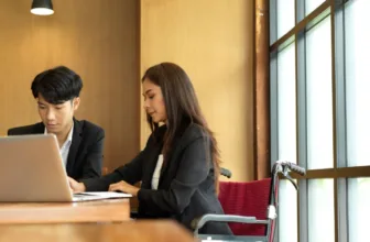 Woman in a wheelchair meeting with insurance agent.