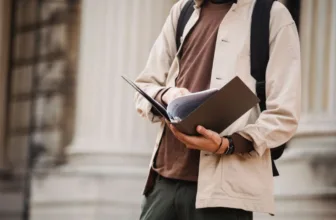 Student looking through a book of scholarships.