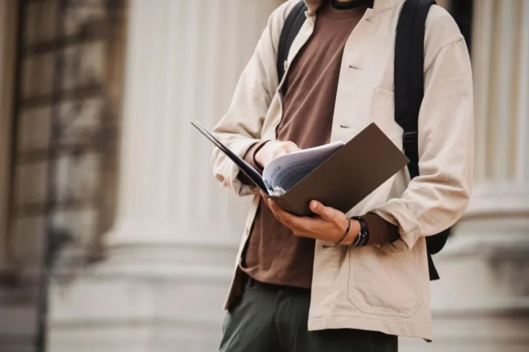 Student looking through a book of scholarships.