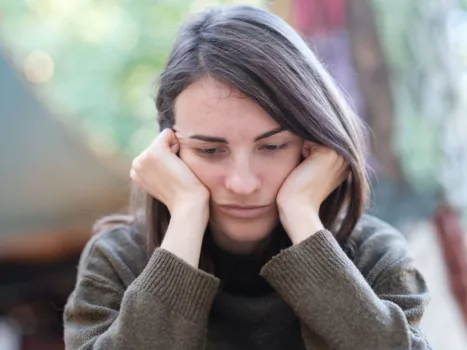 Sad and stressed woman struggling with addiction.