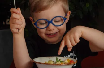 Child with glasses eating.