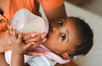 Baby drinking from bottle.