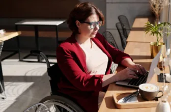 Woman in wheelchair using computer.
