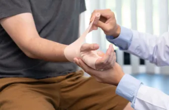 Doctor examining patient's injured hand.