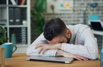 Man falling asleep at desk.