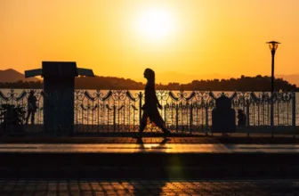 Woman jogging at sunset.