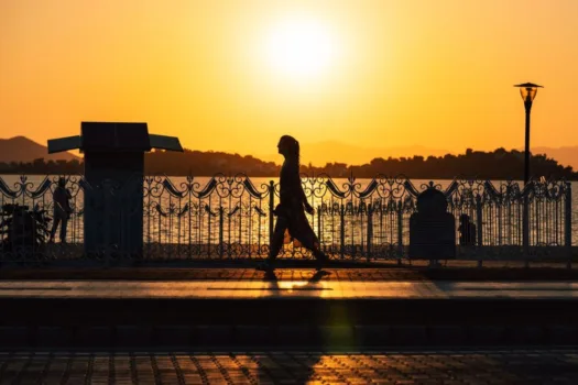 Woman jogging at sunset.